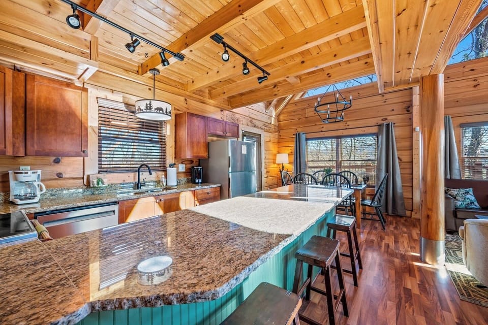 chef's dream in the mountains. This expansive granite island provides ample space for meal prep, entertaining, or casual breakfast seating.
