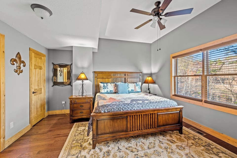 Sweet dreams are guaranteed in this spacious bedroom, anchored by a premium wood bed frame and flanked by classic nightstands.