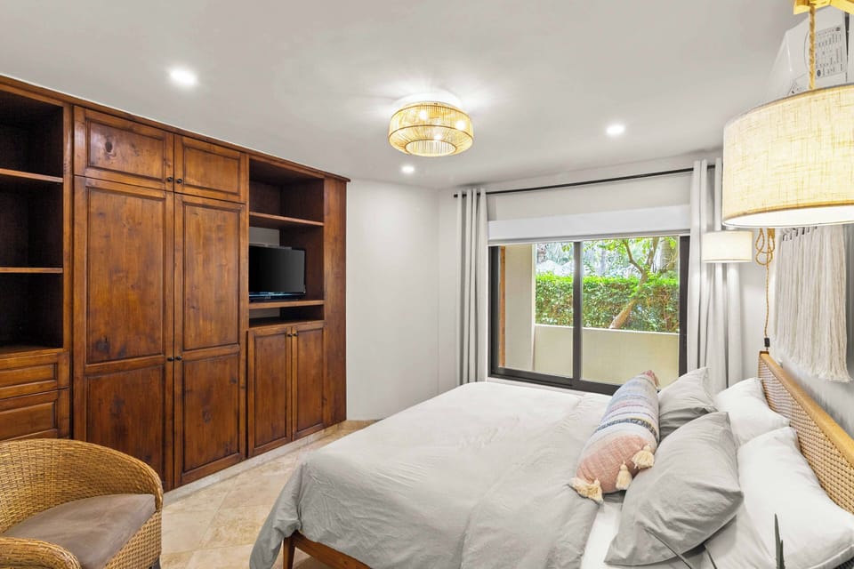 The king bedroom is beautifully decorated with view of the patio and garden 