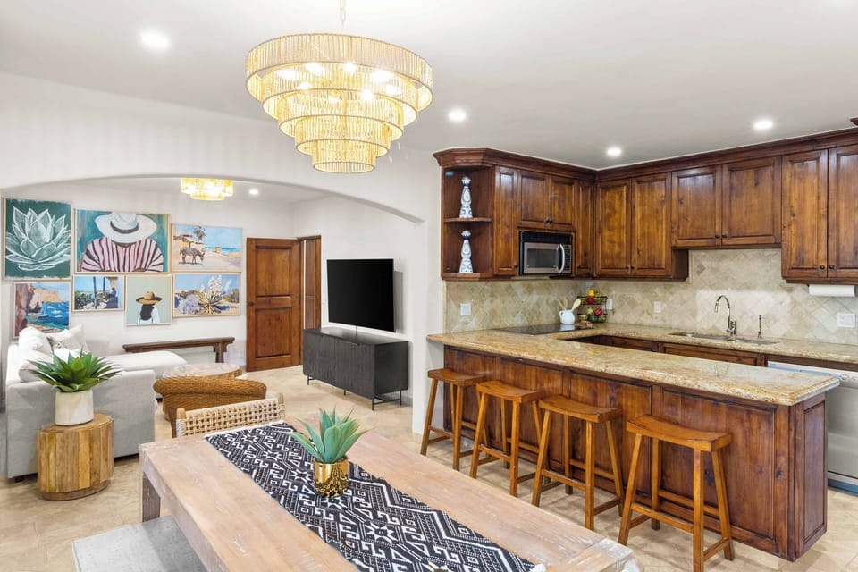 This Cabo Oasis features an open-concept living room, dining area, and kitchen.