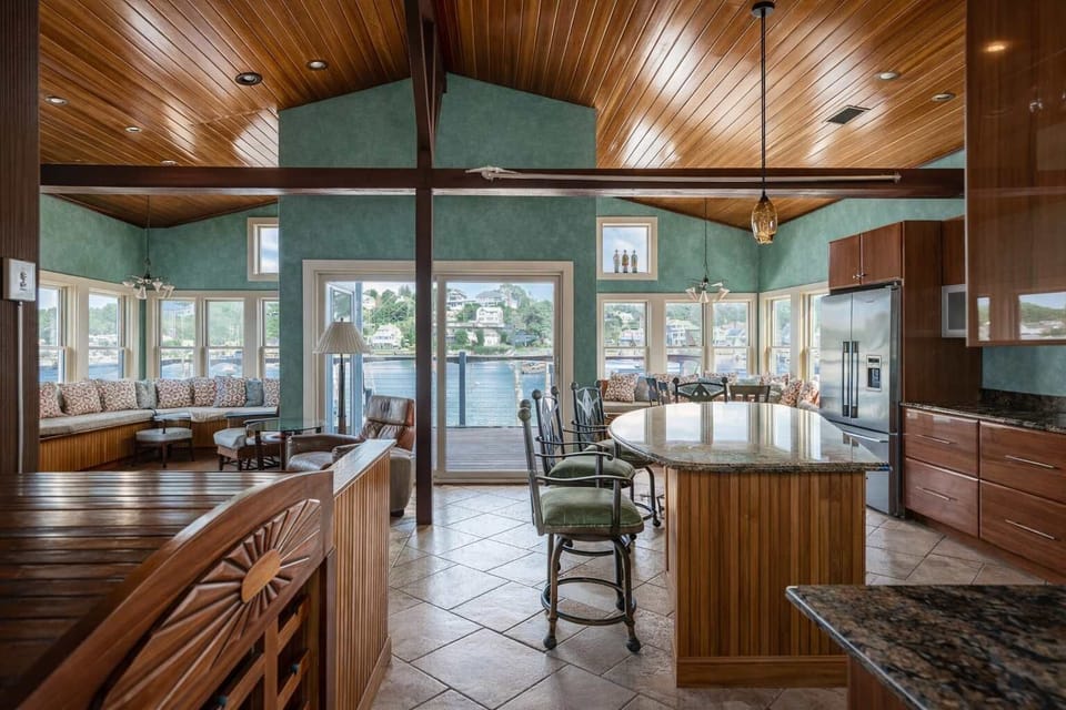 Open-concept kitchen and living area with turquoise finishes