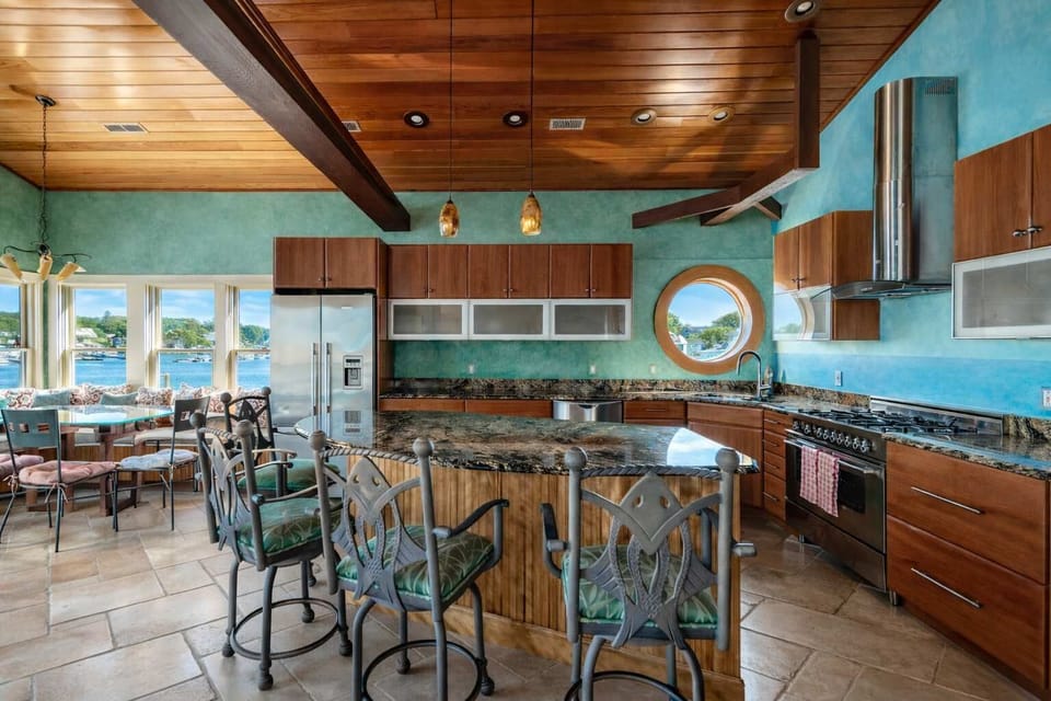 Bright kitchen with turquoise accents and waterfront dining bar