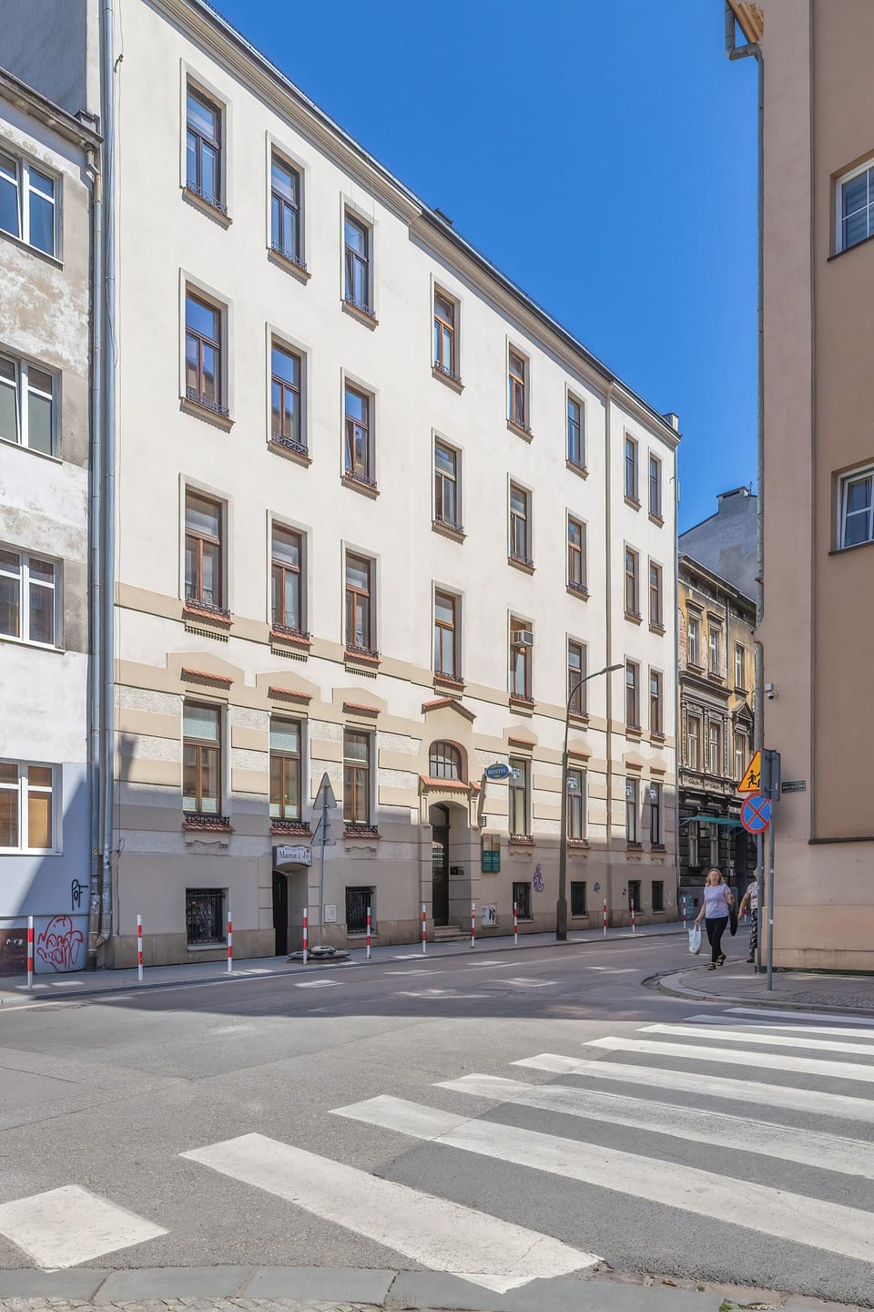 Another exterior shot highlighting the classic facade of the apartment building in its vibrant urban setting.