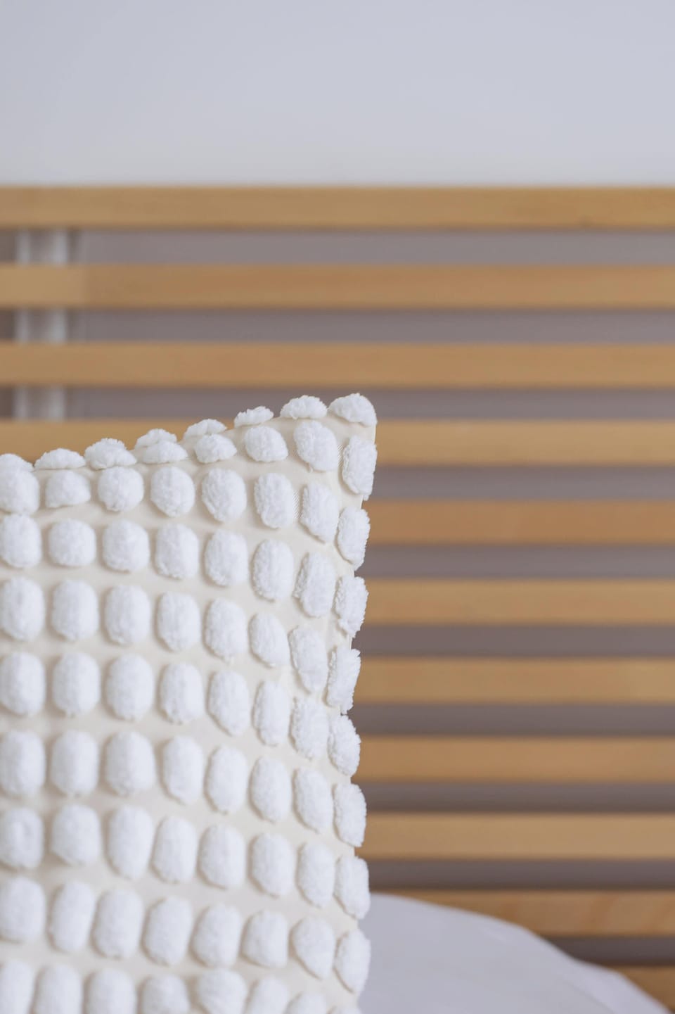 Decorative details / bed with cushions and bedding.