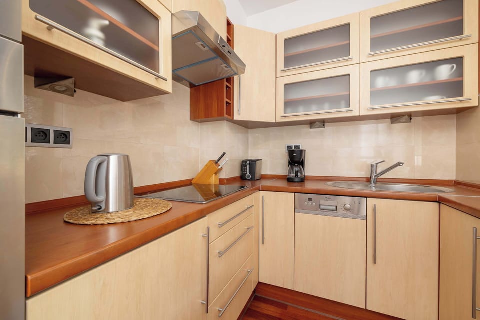 A practical kitchen with modern cabinets and appliances makes everyday cooking easy.
