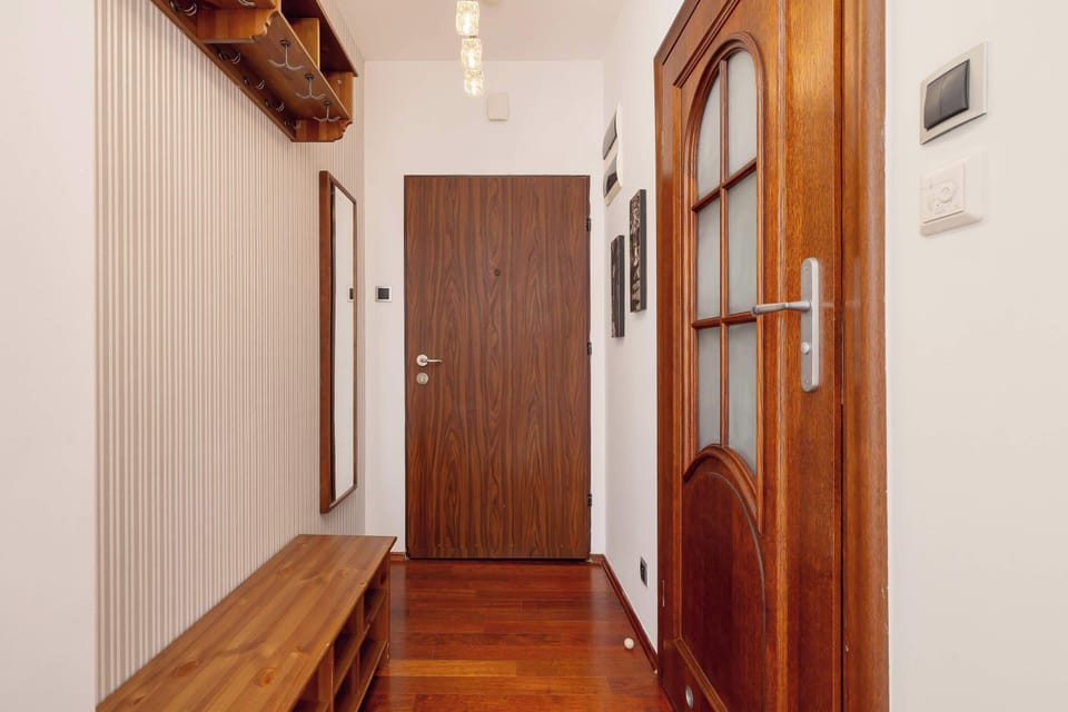 Wooden details and warm lighting in the hallway create a welcoming first impression.