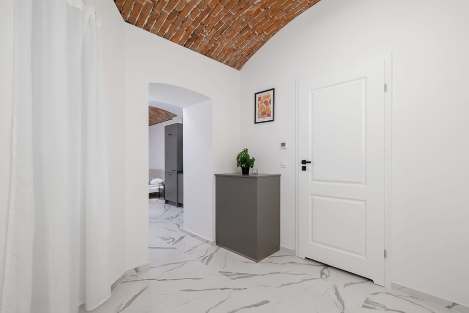A spacious hallway with subtle green touches brings a sense of calm and harmony.