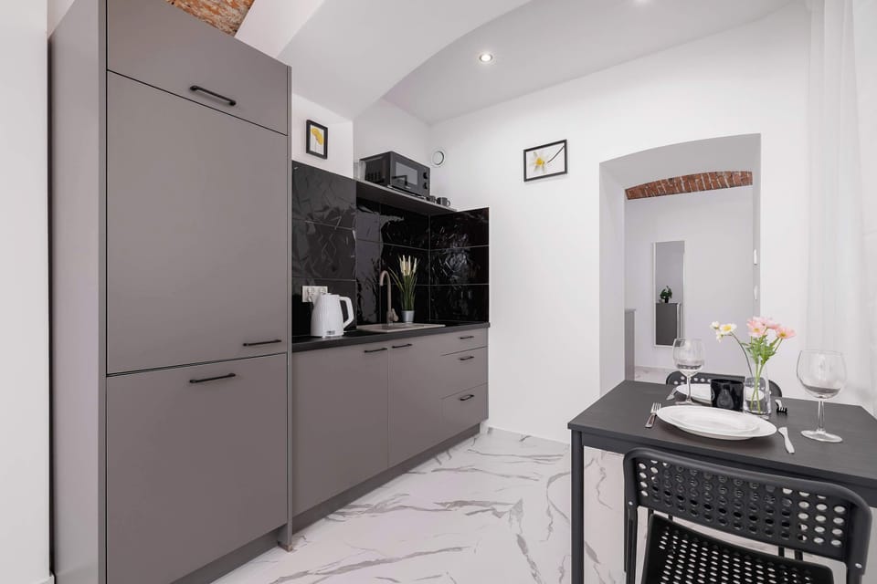 A sleek kitchen with a dining table invites shared cooking and memorable meals.

