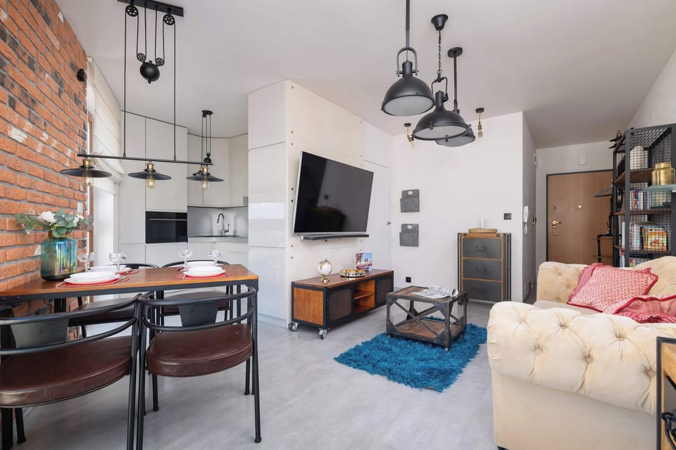 A spacious living room with comfy furniture and a TV offers ideal conditions for relaxation.