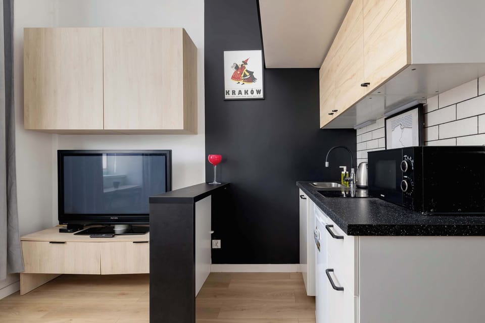 A kitchenette, separated by a countertop from the lounge area.