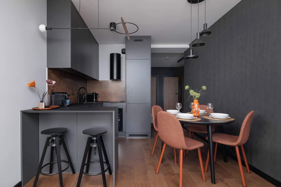 Kitchenette and dining area with table and chairs.