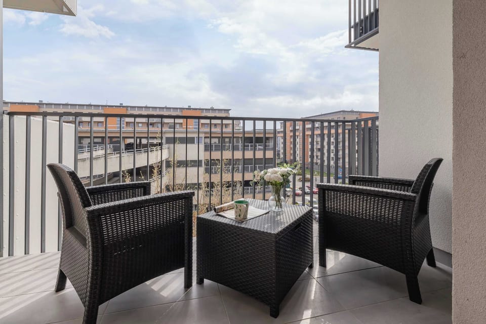 The balcony's stylish design complements the apartment's decor.