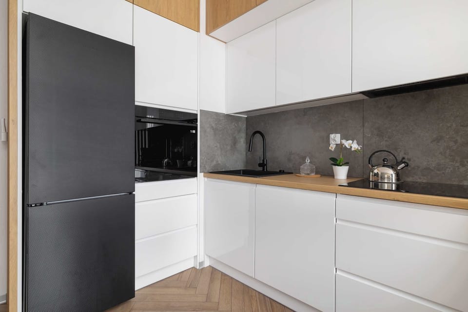 The sleek design of the kitchenette blending seamlessly with the living area.