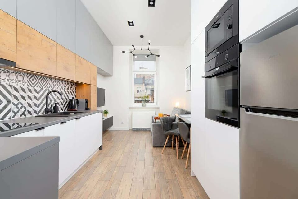 The sleek design of the kitchenette blending seamlessly with the living area.