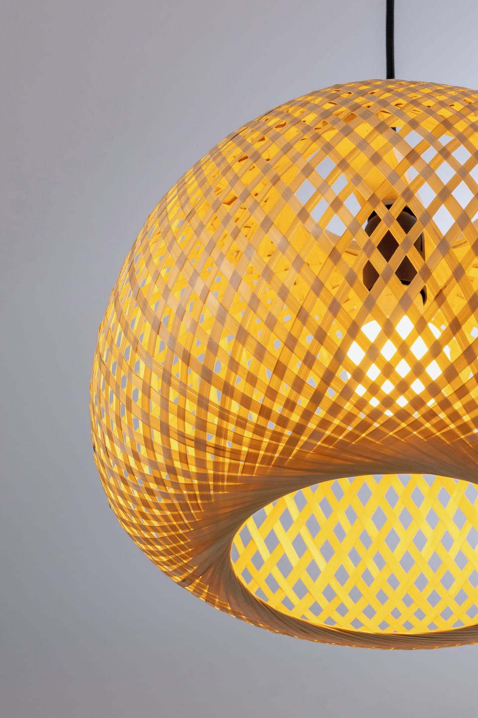 A designer lamp made of natural material adds warmth and unique character to the space.
