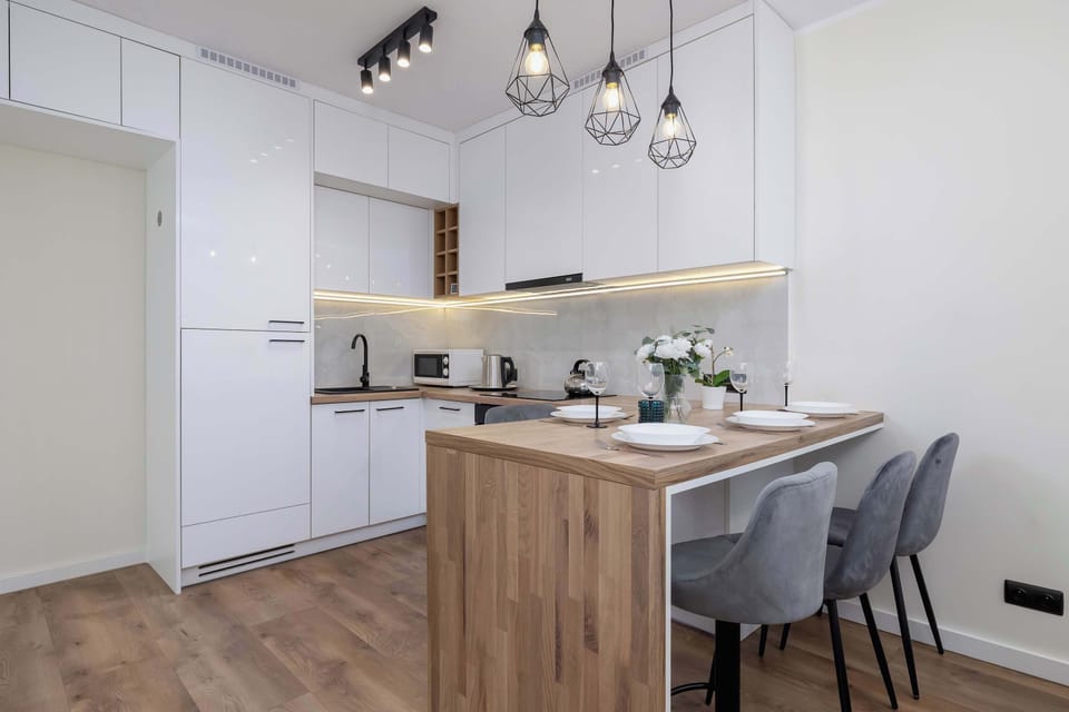 A stylish kitchen with bar stools and subtle lighting is the perfect spot for breakfast or evening wine.