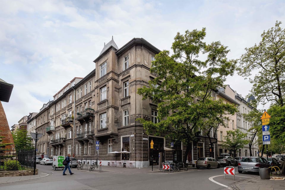 The townhouse facade with balconies and tall windows hints at an interior full of character and history.

