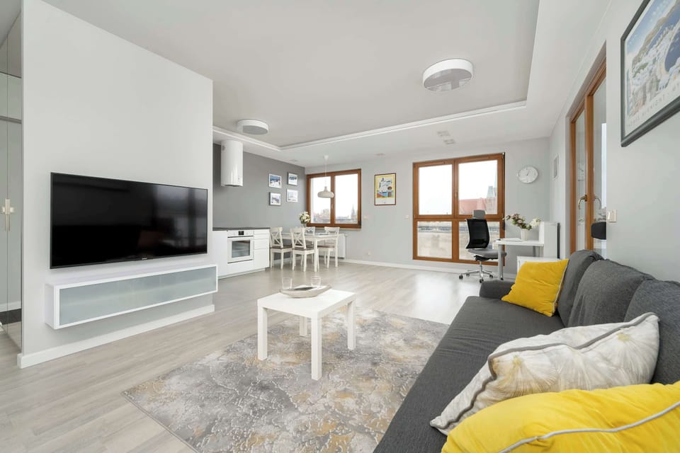 The elegant living room featuring a double sofa bed, perfect for relaxing or sleeping.
