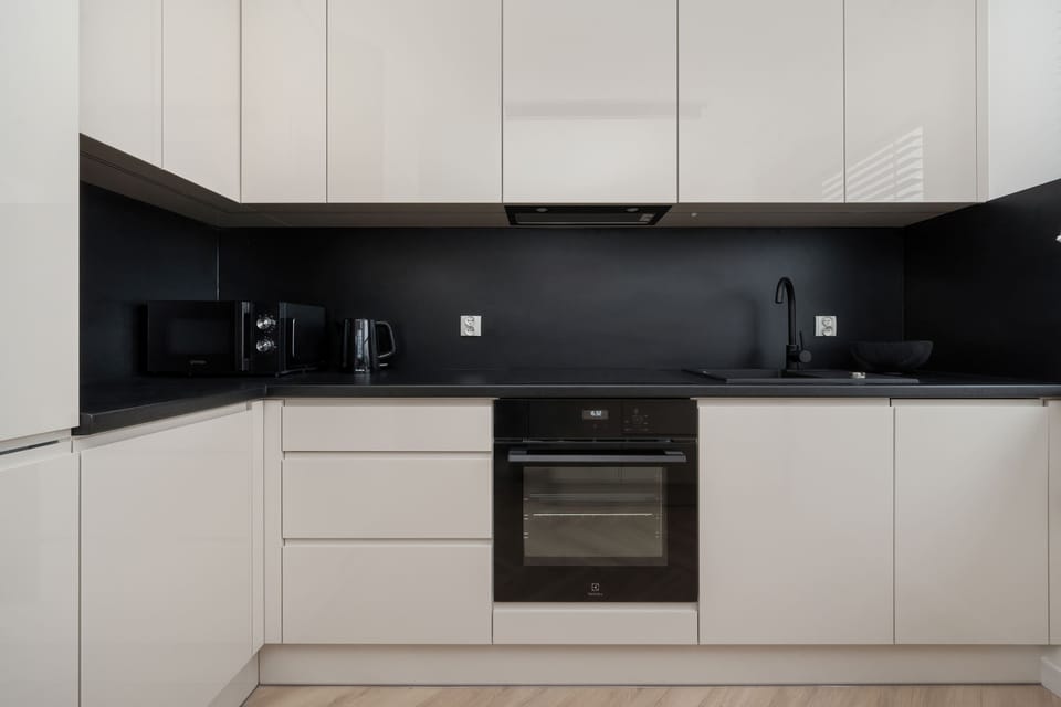 The sleek design of the kitchenette blending seamlessly with the living area.