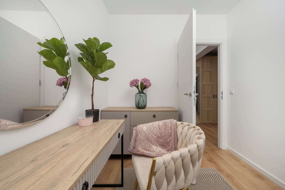 A bright console with a stylish chair in a bedroom. 