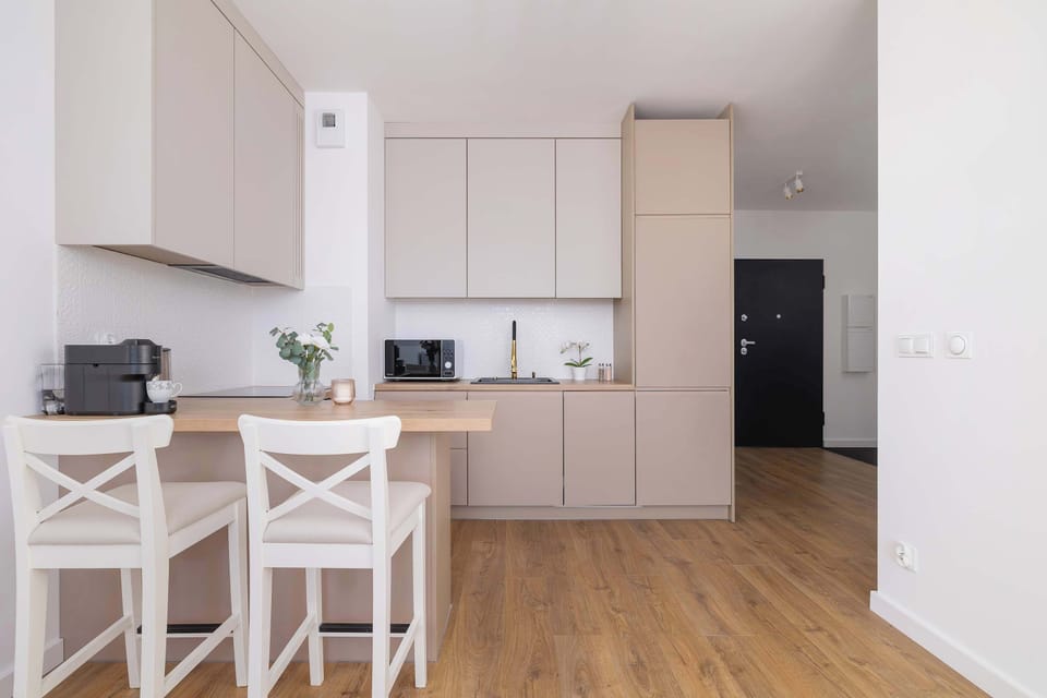 The sleek design of the kitchenette blending seamlessly with the living area.