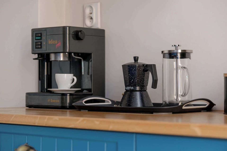 A coffee station with a modern espresso machine and cups.
Perfect for brewing your favorite drinks in the comfort of your home.