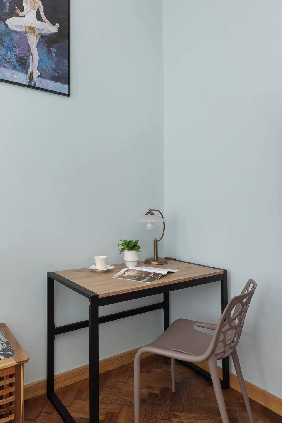A compact desk with a lamp and decorative plant—perfect for working or studying in comfort.