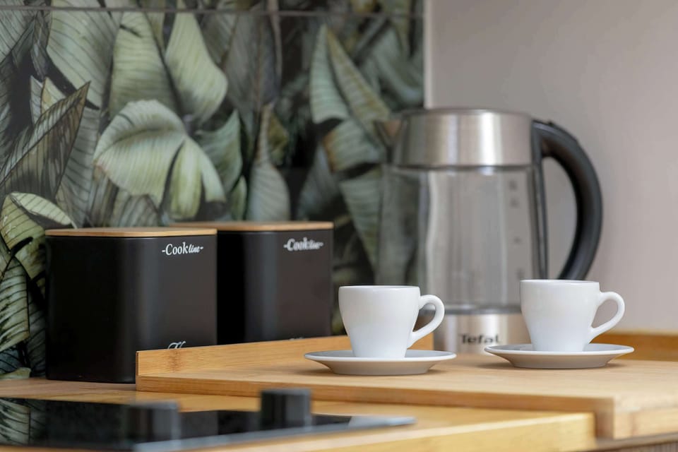 A stylish kitchen countertop with a coffee machine and cups, ready for your morning ritual.