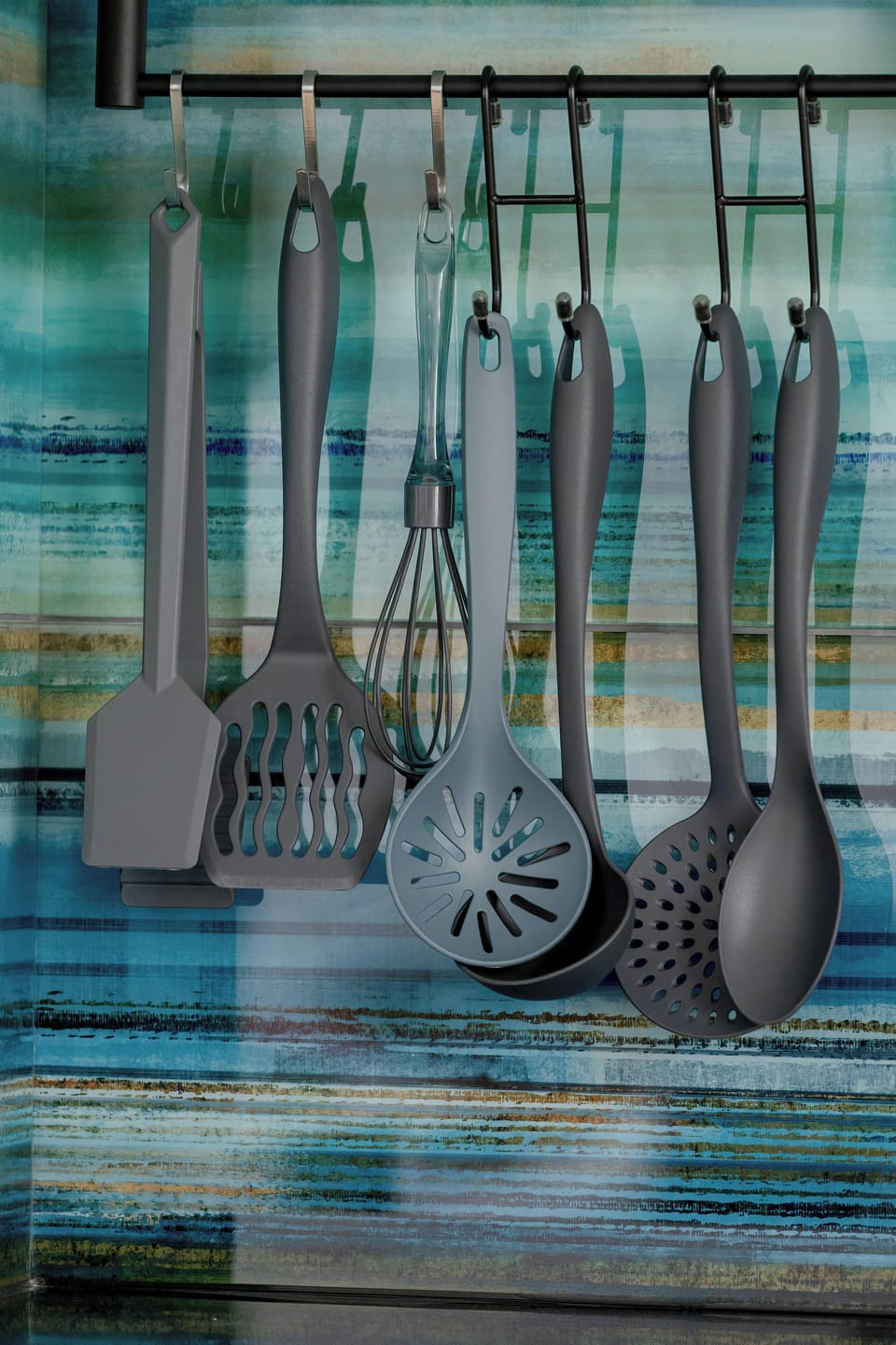 A neatly arranged set of cooking tools, including spoons and a strainer, ready for everyday meal prep.