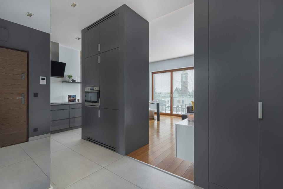 Entryway with full view of open-plan kitchen and lounge area.