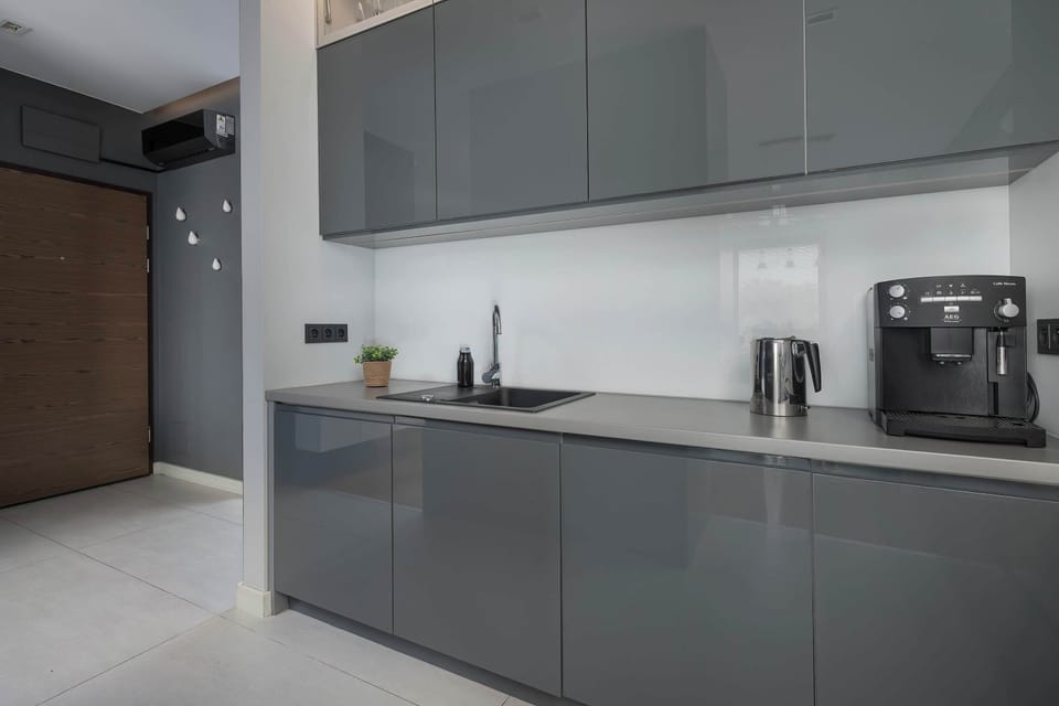 Sleek kitchen with dark gray cabinetry and built-in appliances.