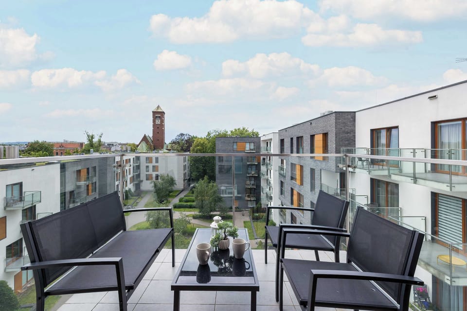 Balcony with city views and seating for two.


