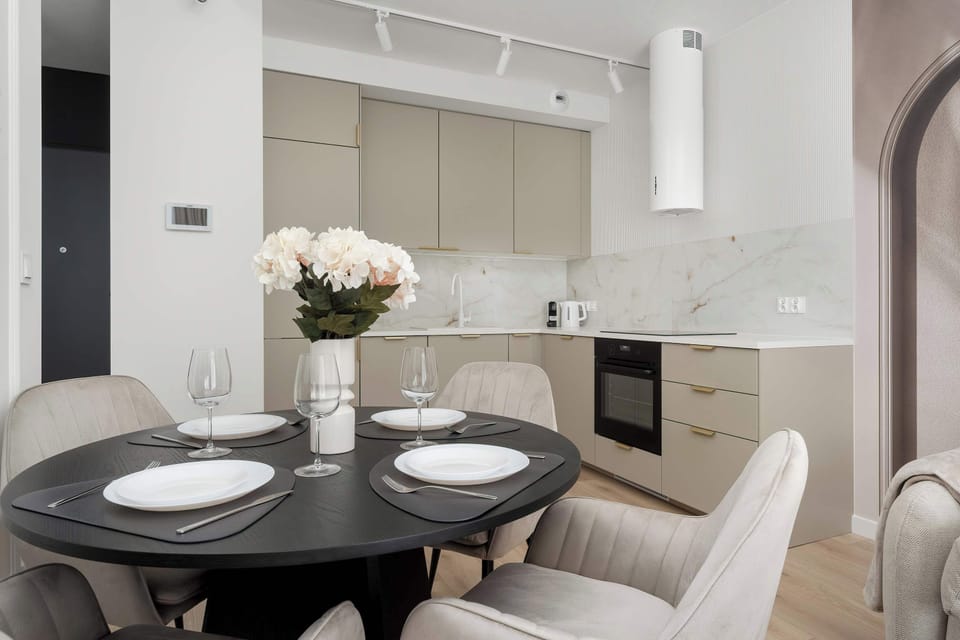 Fully equipped kitchenette with induction cooktop and dining area.