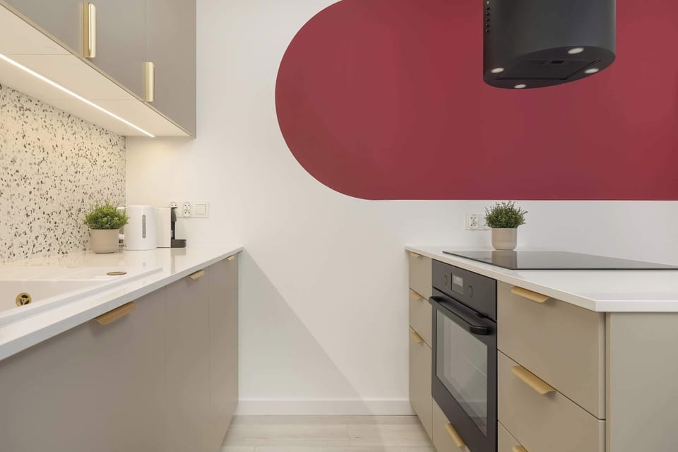 The sleek design of the kitchenette blending seamlessly with the living area.