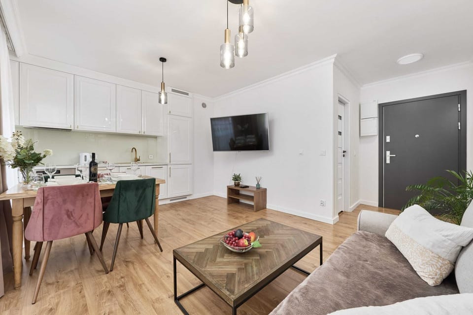  A view showing the flow between the living room and kitchen, emphasizing the bright and open-plan layout.