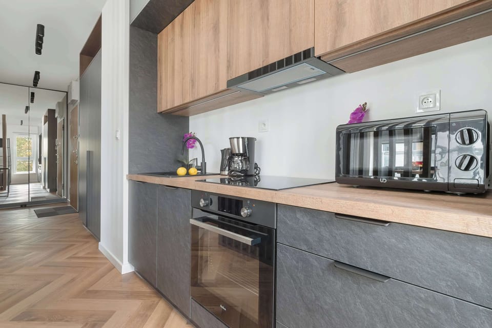 Kitchenette with oven and refrigerator.