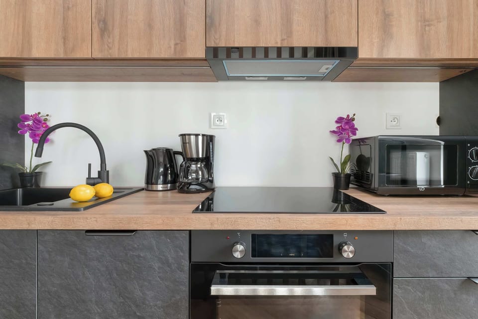 Kitchenette with oven and refrigerator.