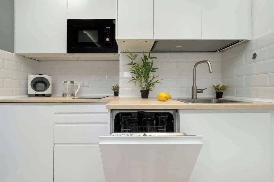 The bright kitchen with a microwave and functional layout is ideal for quick meal prep.