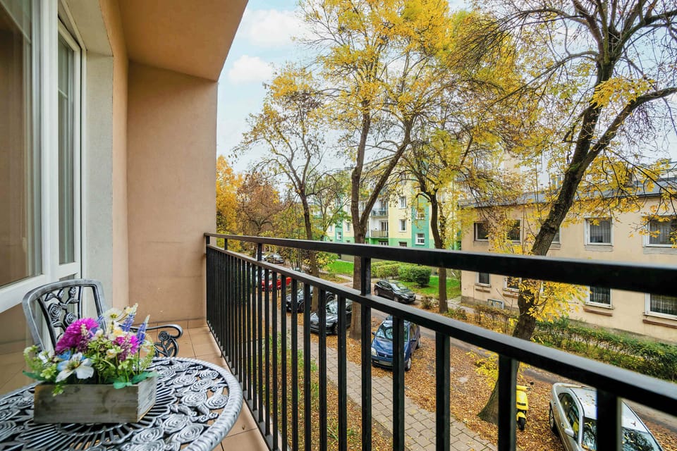 Spacious balcony with table and chairs. 