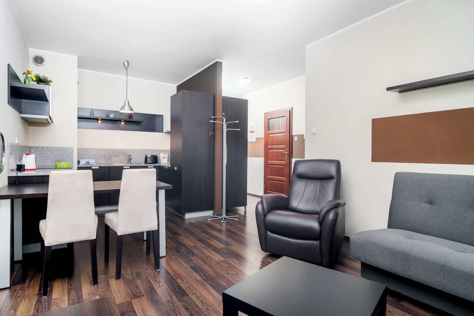 A combined dining and living area, featuring a dining table and chairs near the kitchen. The open-plan layout creates a spacious feel and easy flow between areas.