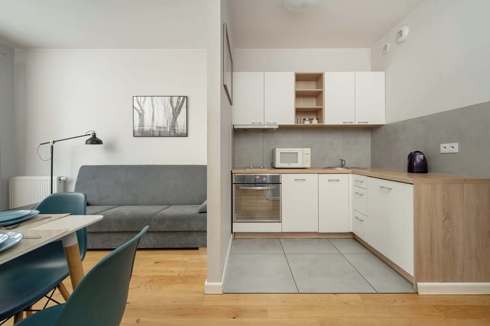 Kitchenette with oven and refrigerator. 