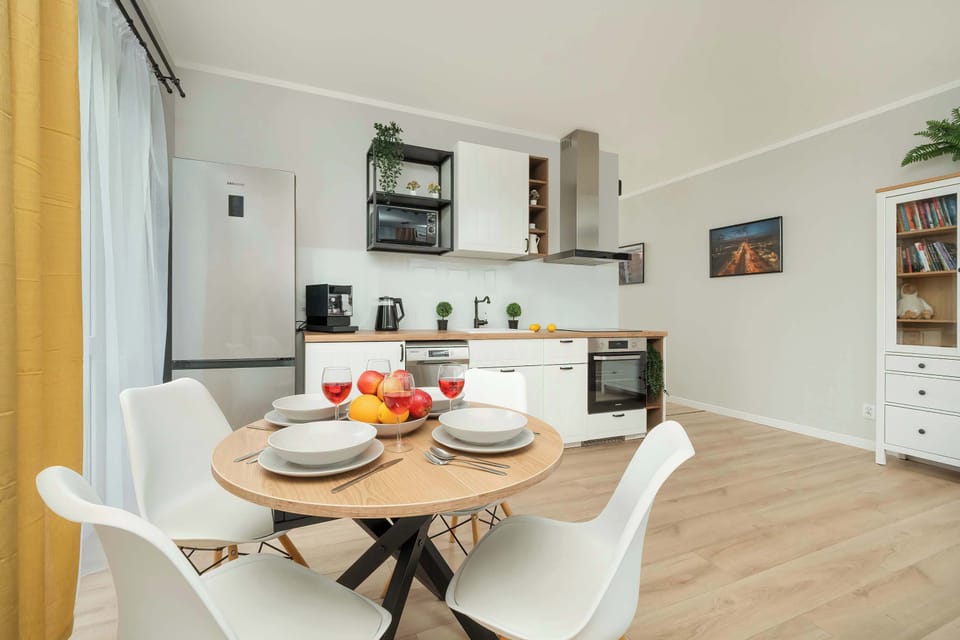 Large table with chairs for eating communal meals.