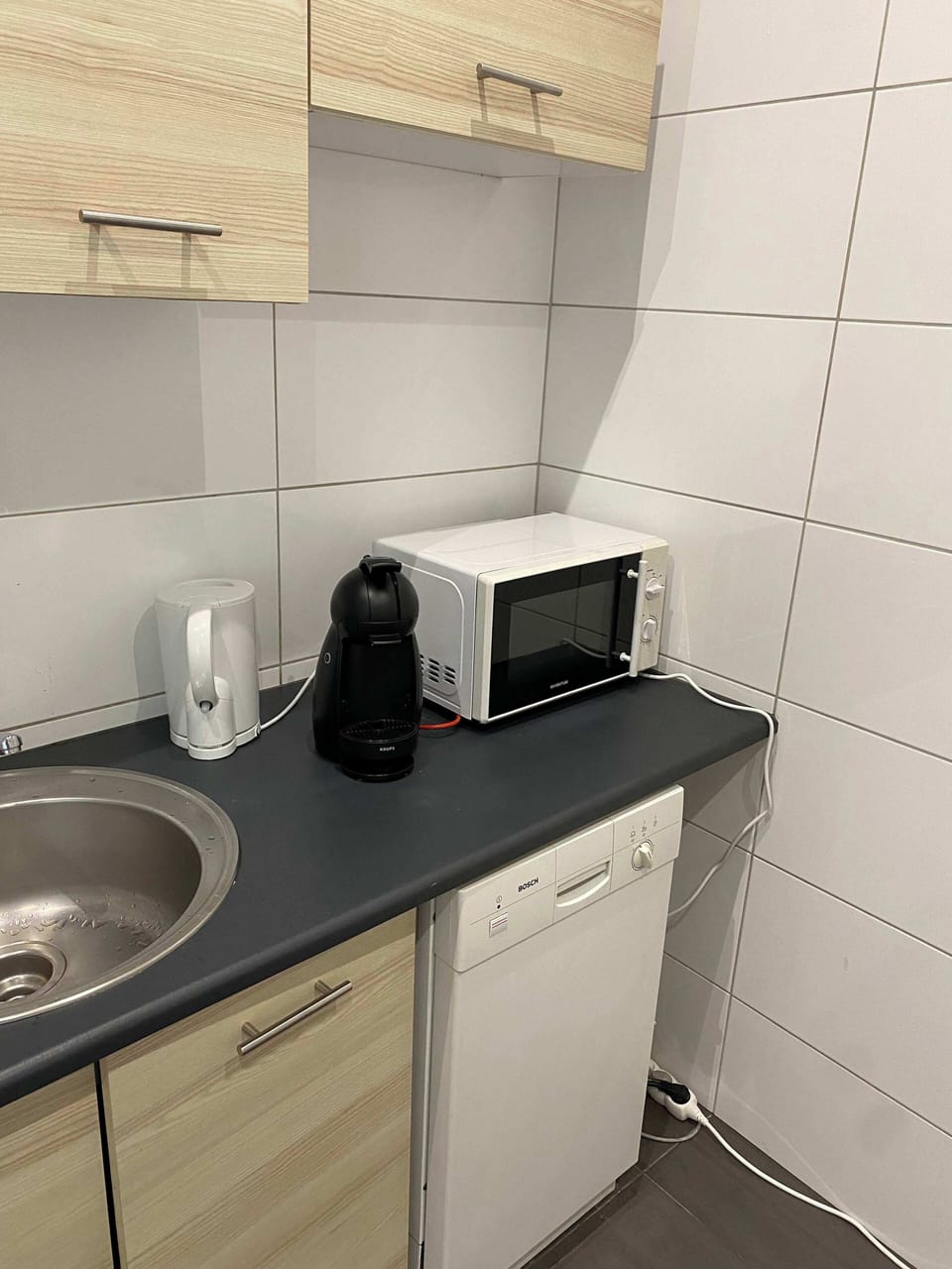 A close-up of the microwave in the kitchen, ready for quick and convenient meal preparation.