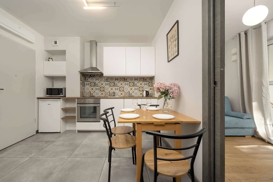 Kitchenette with oven and refrigerator. 