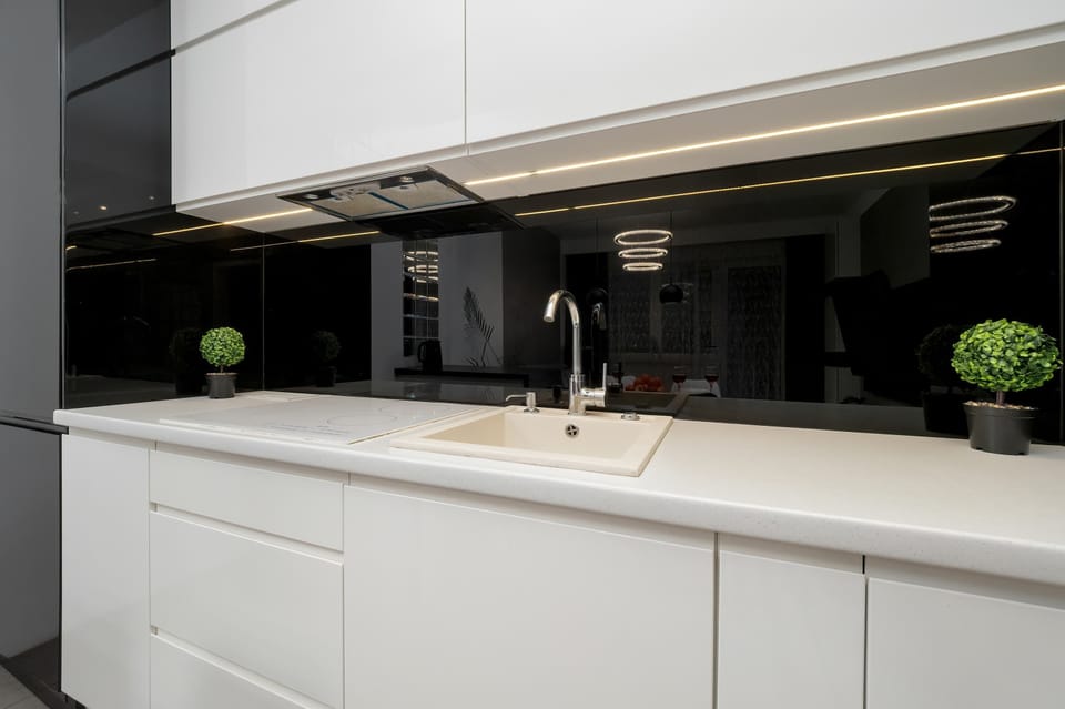 Fully equipped kitchenette with induction cooktop, oven, electric kettle, refrigerator with freezer, microwave and dishwasher.