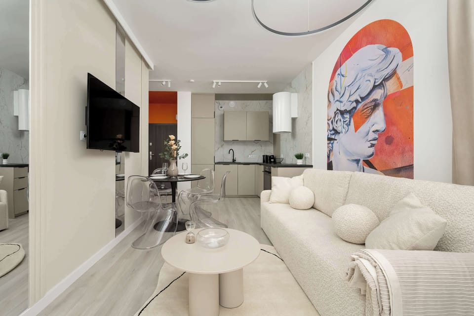 Modern living room with beige sofa and TV on the wall and an interesting decorative element on the wall.