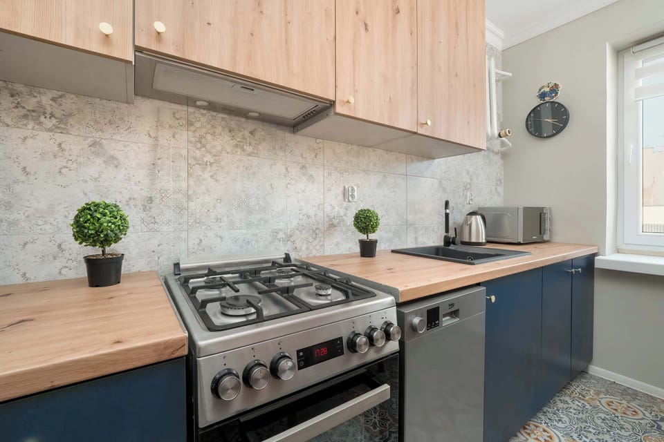 Another angle of the kitchen with a view of the stove, countertop, and a few accessories.