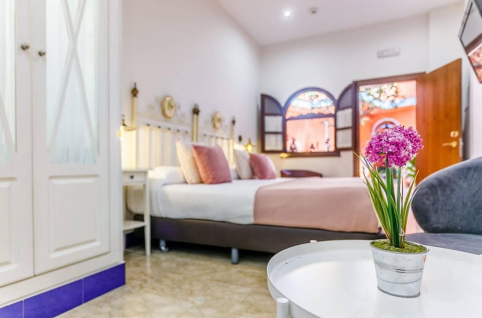 Double Room | Minibar, in-room safe, individually decorated, iron/ironing board