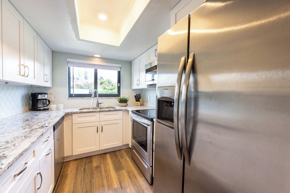 Bright, updated kitchen with stainless steel appliances and ample counter space