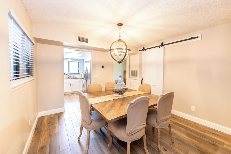Bright dining area with seating for six and open access to kitchen